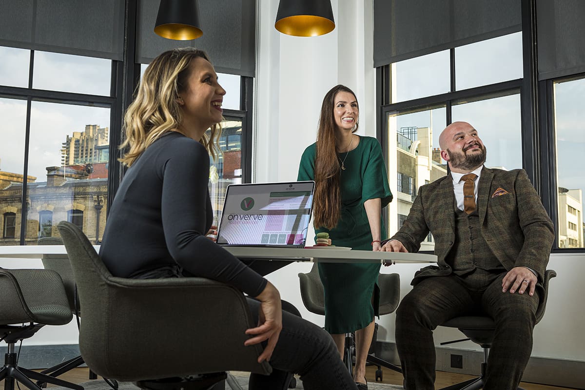 Churchill colleagues in a meeting room looking at a screen. 