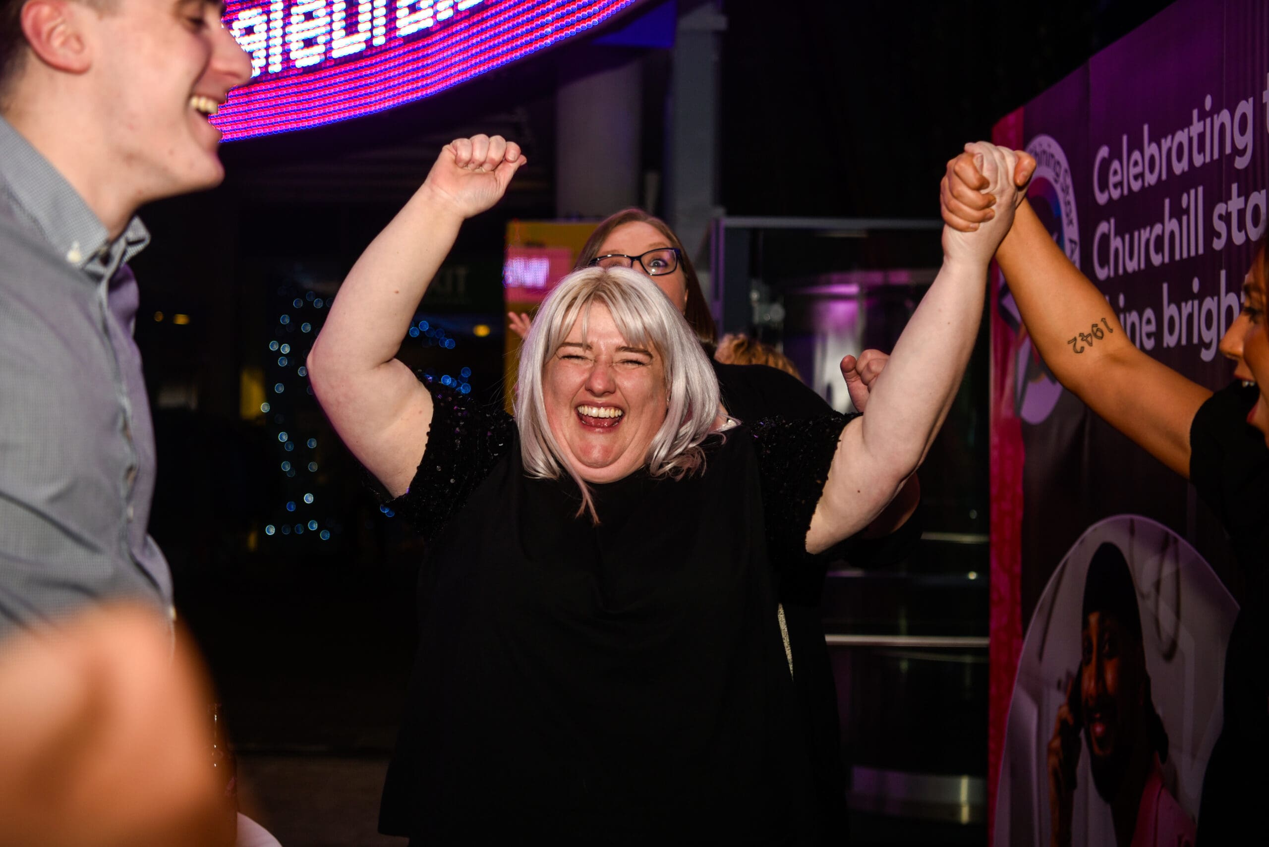 Lady holding her arms in the air in celebration